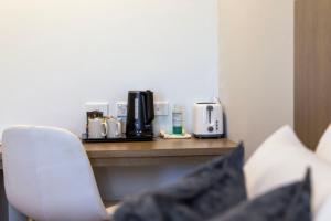 a hotel room with a counter with a coffee maker at Modern Queen Studio - 6 Mins to Callala Beach in Callala Beach