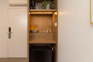 a kitchen with a shelf with a sink in it at Modern Queen Studio - 6 Mins to Callala Beach in Callala Beach