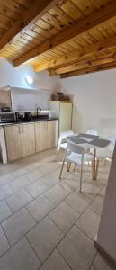 a kitchen with a table and chairs in a room at Depto El Mirador in Plaza Huincul