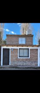 a brick building with two windows on top of it at Depto El Mirador in Plaza Huincul