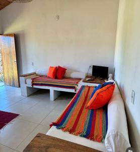 a living room with a couch with a laptop on it at Casa Mangaba da Praia in Prado