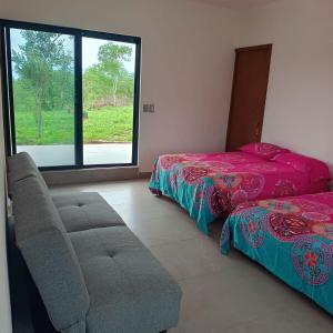 a bedroom with a bed and a couch and a window at Quinta Bello Cielo in Montemorelos +22 photos