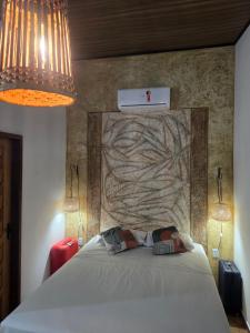 a bedroom with a bed with two pillows on it at Tapioca Vila Boutique in Atins