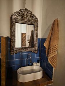 a bathroom with a large mirror and a tub at Tapioca Vila Boutique in Atins