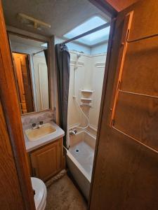 a bathroom with a sink and a toilet and a tub at Casa Rodante Tony 1 in San Felipe +7 photos