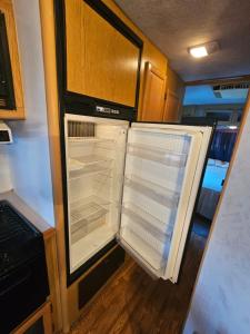 an empty refrigerator with its door open in an rv at Casa Rodante Tony 1 in San Felipe