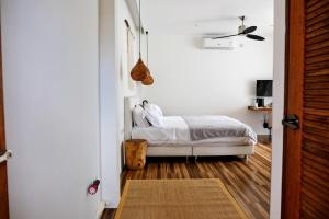 a bedroom with a bed in a white room at Hillside Koh Samui in Ban Khlong Mae Nam +31 photos