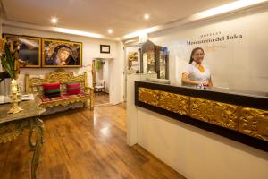 a woman standing behind a counter in a store at Hotel Monasterio del Inka Cusco in Cusco