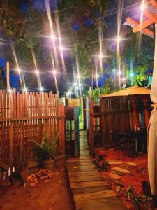 a room with a fence and a table and lights at Mucajá Glamping com charme a poucos passos da Ilha in Alter do Chao +17 photos
