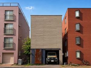 a car parked in a garage between two buildings at Haus128 in Sapporo