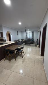 a large kitchen and living room with a table and chairs at الدانه1 in Al Wajh