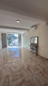 an empty living room with a stone floor and a fireplace at الدانه1 in Al Wajh