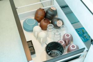a drawer filled with vases and other items at AoAsoVilla in Aso +22 photos