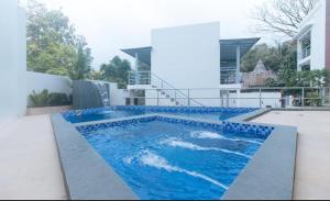 a swimming pool on the side of a house at Grospe Resort Boracay in Boracay