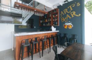 a bar with a bunch of bar stools in a restaurant at Grospe Resort Boracay in Boracay +2 photos