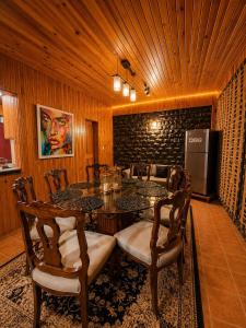 a dining room with a table and chairs at Haven Hilltop Cottage, Dunga Gali in Dunga Gali +39 photos