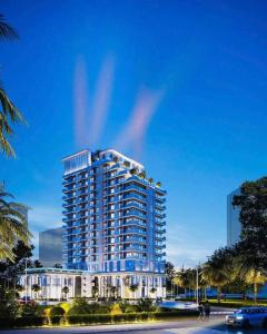 a tall white building with a lot of windows at Khách sạn LAzur in Cửa Lô