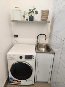 a small kitchen with a microwave and a sink at Warkworth Barn Retreat in Warkworth +2 photos