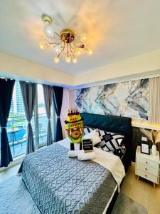 a bedroom with a bed with a cake on top of it at Azure South by Dream Escapade in Manila +27 photos