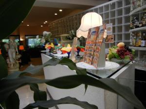 a counter in a store with a plant in the foreground at Delle Nazioni Milan Hotel in Milan