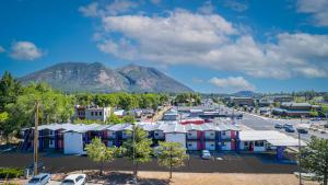 an aerial view of a parking lot with mountains in the background at The Inn On 66 Flagstaff in Flagstaff