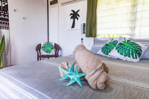 a bedroom with a bed with a towel starfish on it at Ariki Retreat - Adults Only in Rarotonga