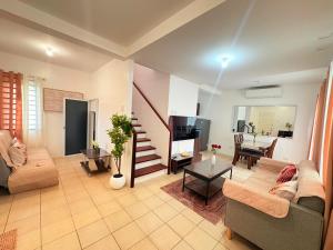 a living room with a couch and a table at Casa Tranquila Panglao in Dauis