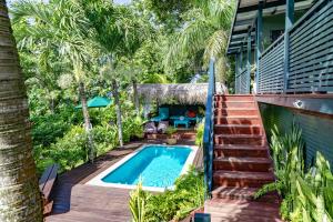 an image of a backyard with a swimming pool and stairs at Ariki Retreat - Adults Only in Rarotonga