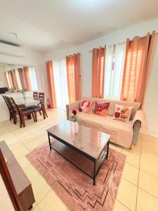 a living room with a couch and a coffee table at Casa Tranquila Panglao in Dauis