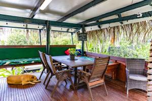 a dog laying on the floor next to a table at Ariki Retreat - Adults Only in Rarotonga