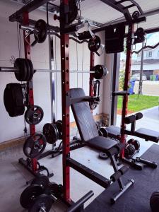 a gym with lots of equipment in a garage at The Onyx Suite Sleek Modern Space Private Entry in Regina