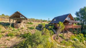 a log home with a deck and a house at Mountain Cabin private hot tub and swimming pool in Wolseley