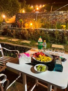 a white table with two plates of fruit on it at Moon Mist Villa- Hatton in Hatton