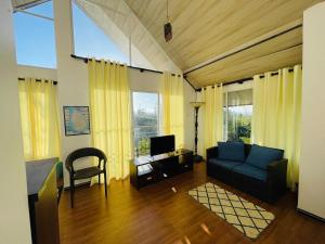 a living room with a couch and a tv at Moon Mist Villa- Hatton in Hatton