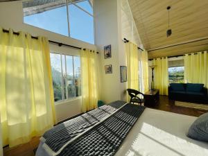a bedroom with a bed and a large window at Moon Mist Villa- Hatton in Hatton