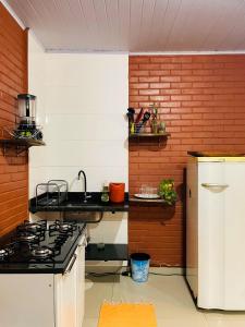 a kitchen with a sink and a stove in it at Casa Vilarejo São Jorge in Sao Jorge