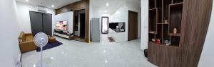 a living room with a television and a white floor at Moon bay 384 in Ðoan Xá