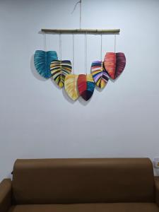 a group of colorful hearts hanging from a ceiling at Moon bay 384 in Ðoan Xá +1 photo