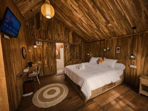 a bedroom with a bed in a wooden cabin at Glamour camping bedugul in Bedugul