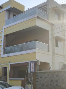 a large building with a balcony on the side of it at Taj Palace in Covelong