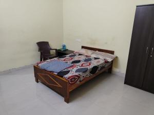 a bedroom with a bed and a desk and chairs at Taj Palace in Covelong