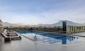 a swimming pool on the roof of a building at Atria Hotel Malang in Malang