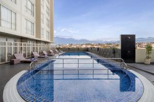 a swimming pool on the roof of a building at Atria Hotel Malang in Malang