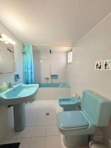 a bathroom with a sink and a toilet and a tub at Mega Panorama Apartments in Paleo Tsifliki +51 photos