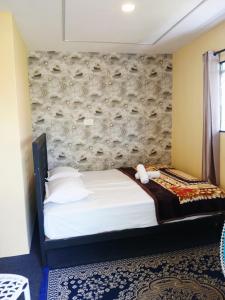 a bedroom with a bed with a teddy bear on it at Varattumedu Hill in Vagamon