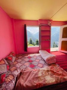 a bedroom with a large bed and a window at Skyblue cafe in Tosh
