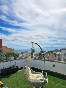a swing on the roof of a building at Diamond Suite in Nea Kallikrateia +5 photos