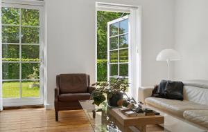 a living room with a couch and a chair at Nice Home In Idestrup With Wifi in Idestrup