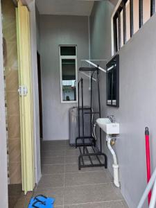 a bathroom with a sink and a mirror and a toilet at PJ Luxury Homestay in Sipitang +4 photos