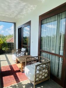 a balcony with two chairs and a table at The balangan studio room 7 in Bingin Beach